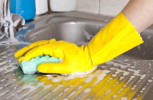 Professional cleaner working in a Kingstonuponthames bathroom