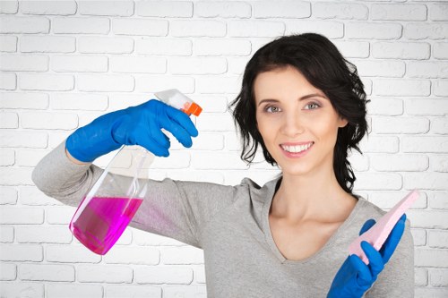Professional cleaner inspecting carpet condition before treatment